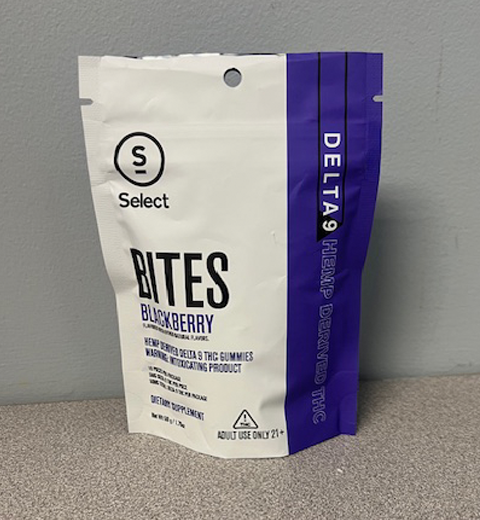 A standing white and purple package labeled "Select Bites, Blackberry." It advertises hemp-derived Delta 9 THC gummies and includes warnings about age restriction and usage. The package is against a gray background.